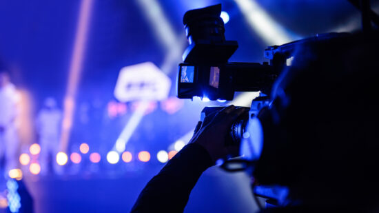 Professional TV cameraman during event recording